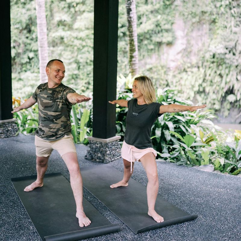 Man demonstrating strength and flexibility in a yoga warrior pose.